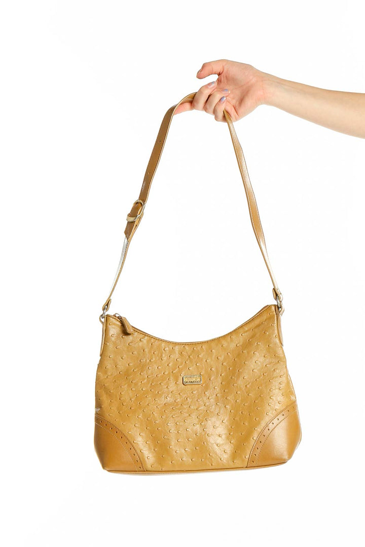 Front view of tan textured Carryland shoulder bag held by hand