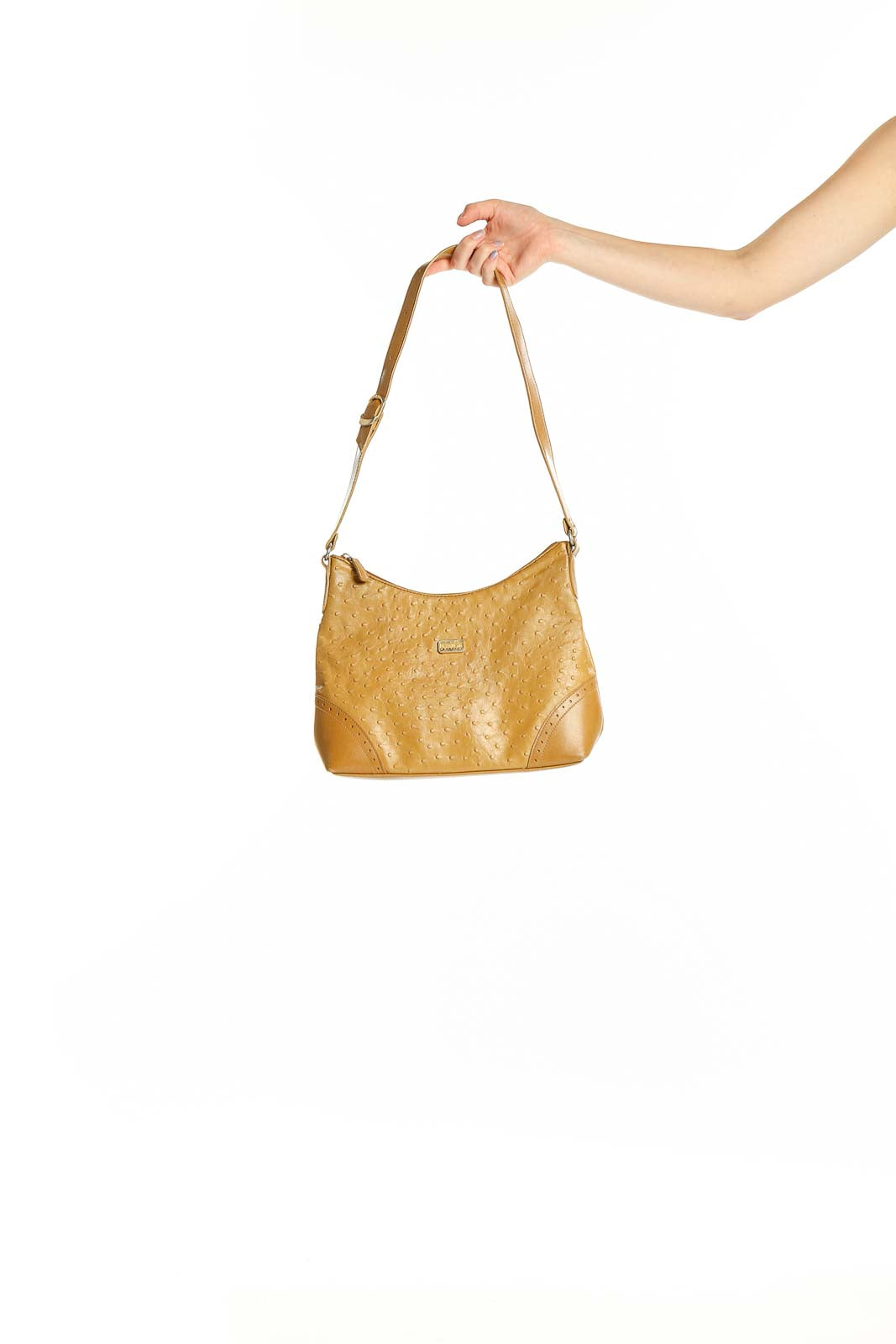 Front view of tan textured Carryland shoulder bag held by hand