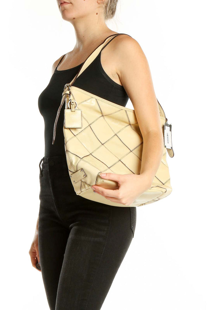 Front view of Tignanello beige quilted leather hobo bag with silver hardware