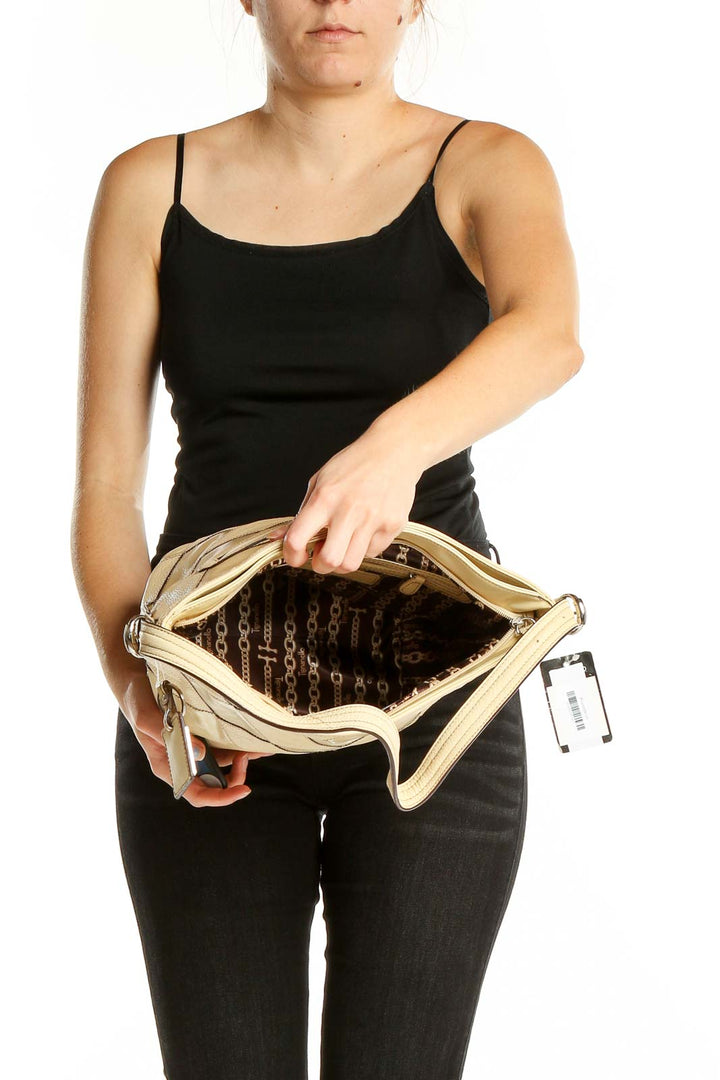 Interior view of Tignanello beige quilted leather hobo bag showing spacious compartment