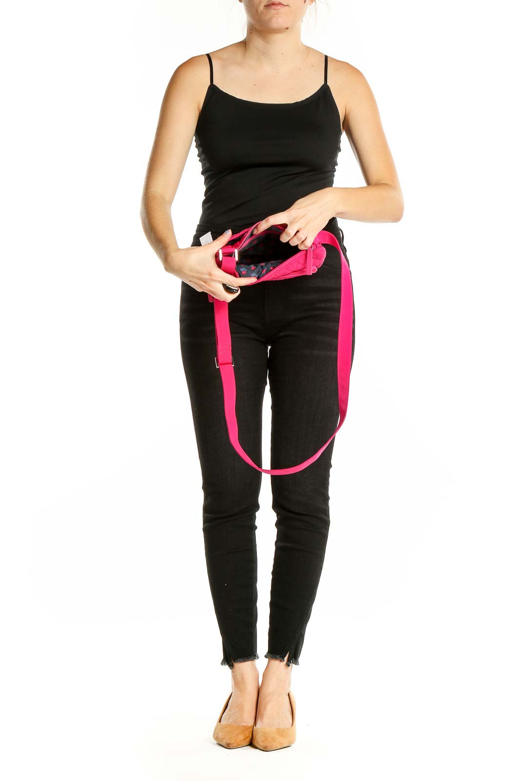 Model wearing hot pink quilted Vera Bradley crossbody bag with black outfit