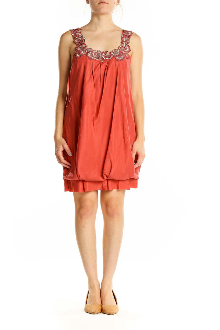 Front view of coral BCBG MaxAzria bubble dress with embellished neckline