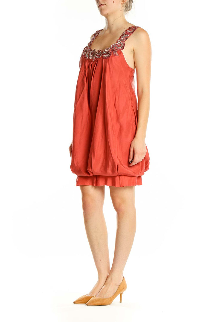 Front view of coral BCBG MaxAzria bubble dress with embellished neckline