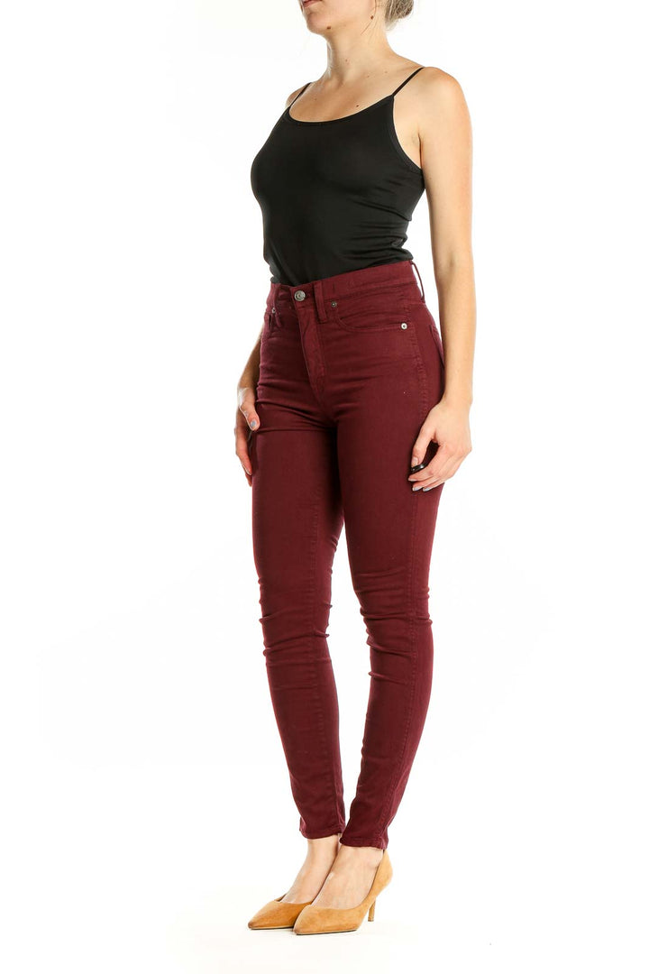 Front view of Madewell burgundy high-waisted skinny pants on model