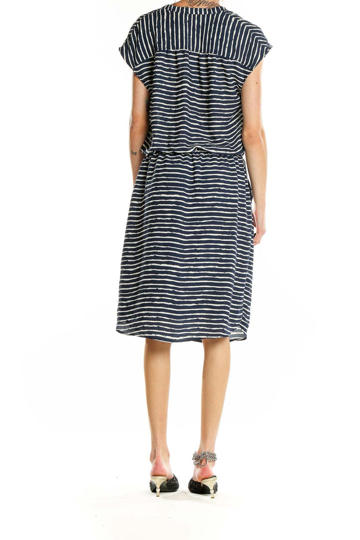 Side view of Banana Republic navy striped V-neck midi dress showing elastic waistband