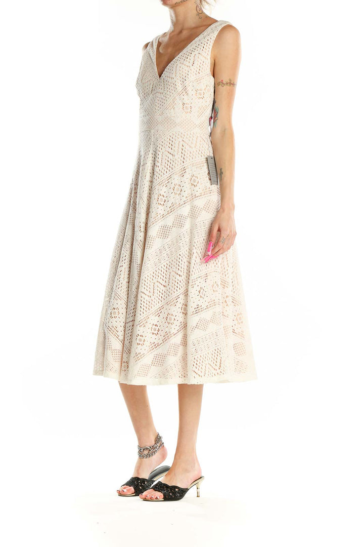 Front view of Vince Camuto cream lace midi dress with V-neckline