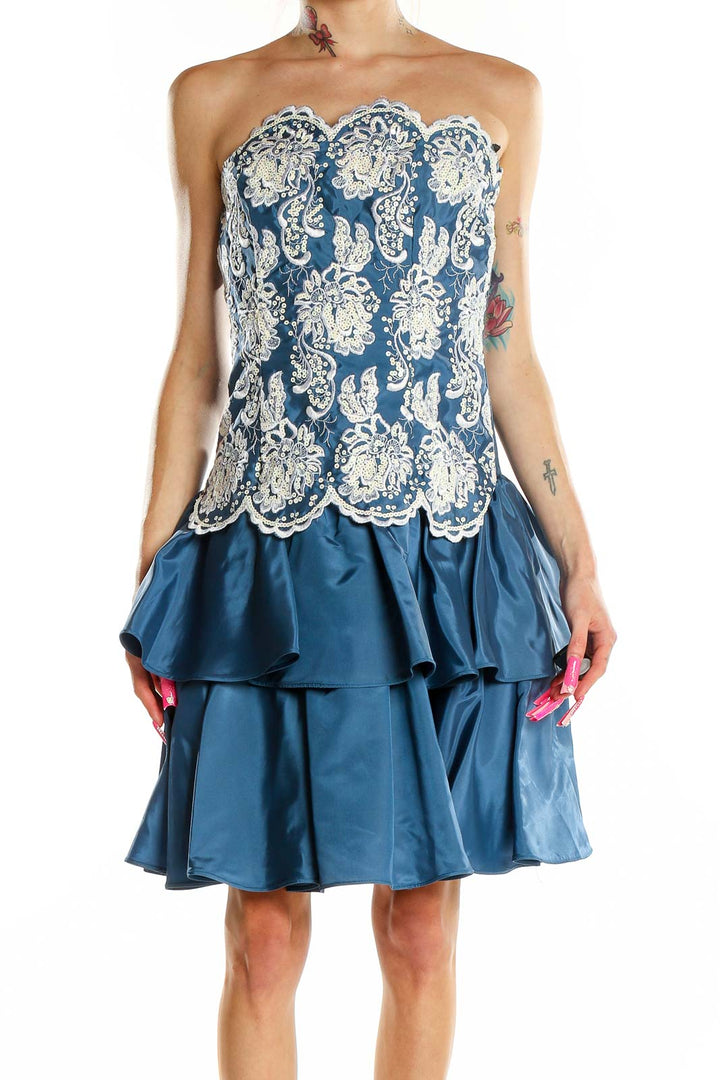 Front view of Scott McClintock blue cocktail dress with white lace overlay and tiered skirt