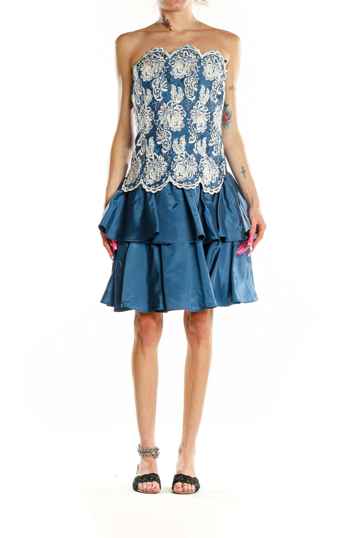 Front view of Scott McClintock blue cocktail dress with white lace overlay and tiered skirt