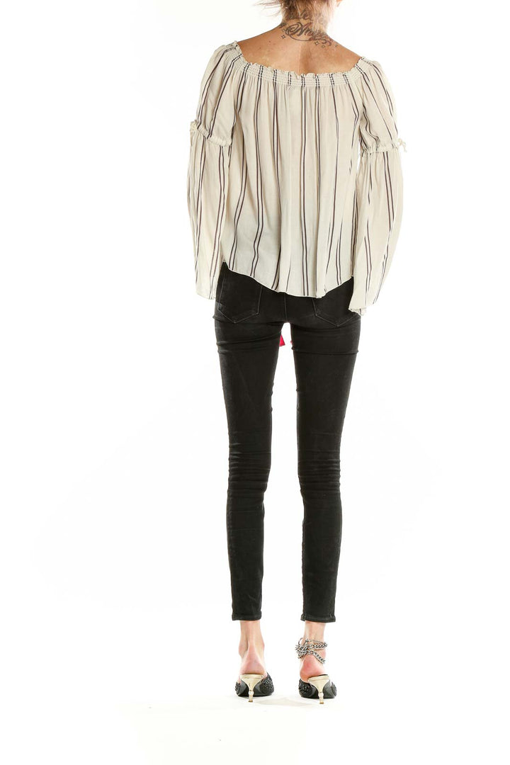 Back view of Chaser beige striped off-shoulder blouse paired with black pants