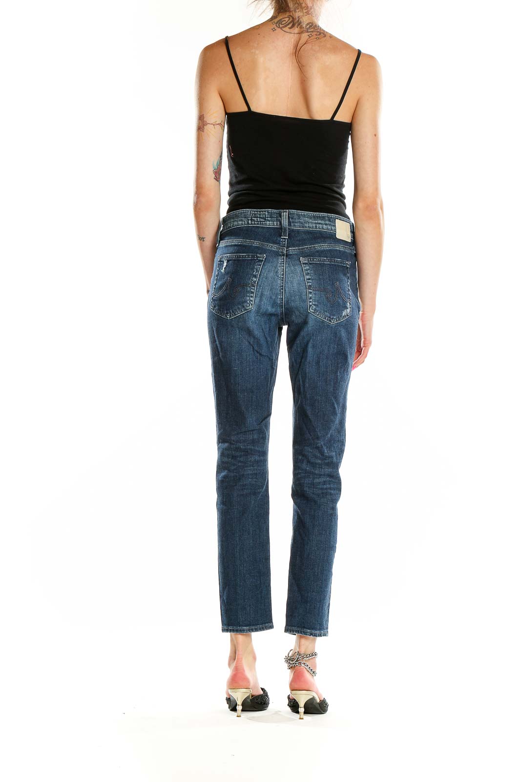 Side view of AG blue distressed slim fit jeans on model