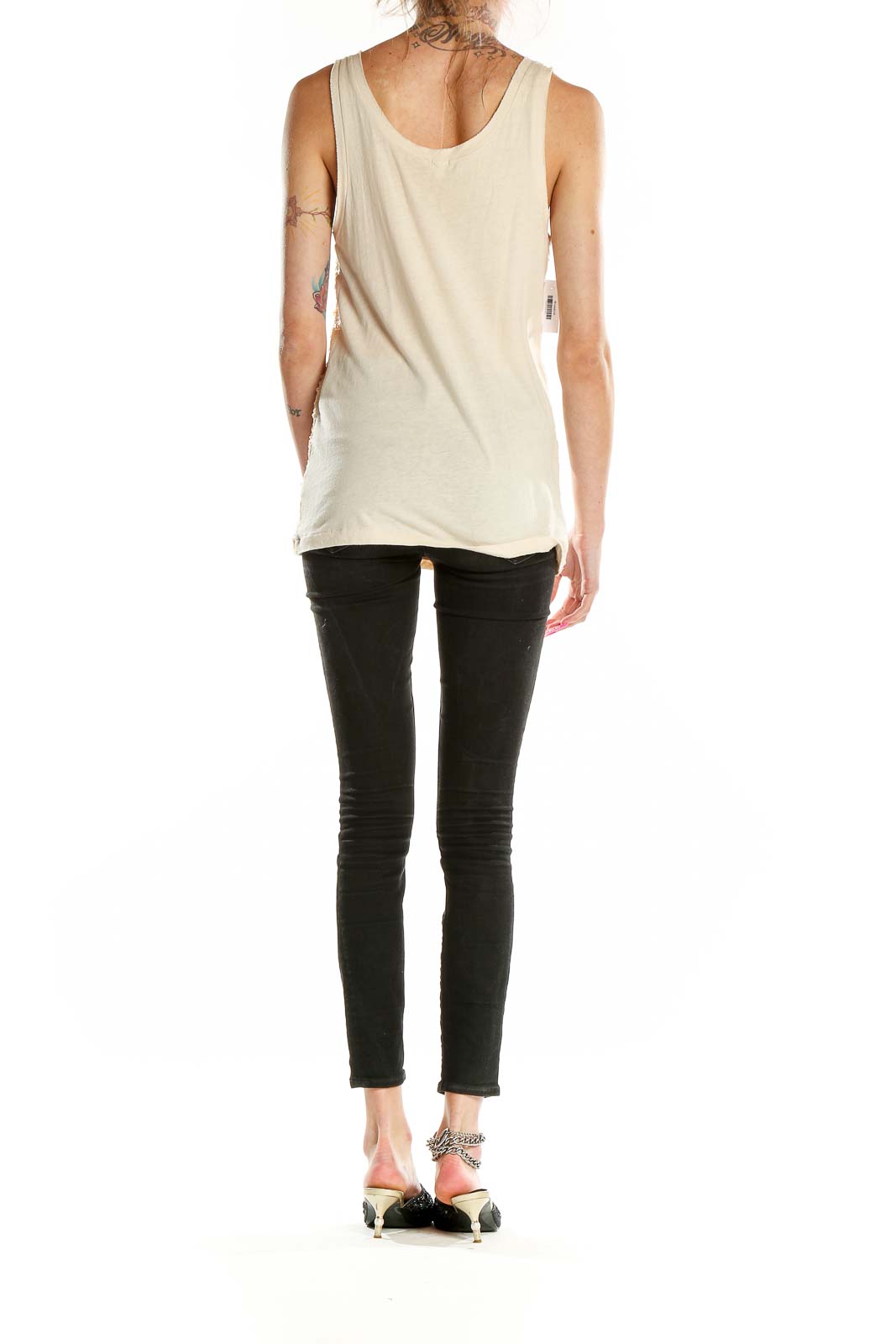 Side view of J.Crew cream sequined tank top on model with black pants