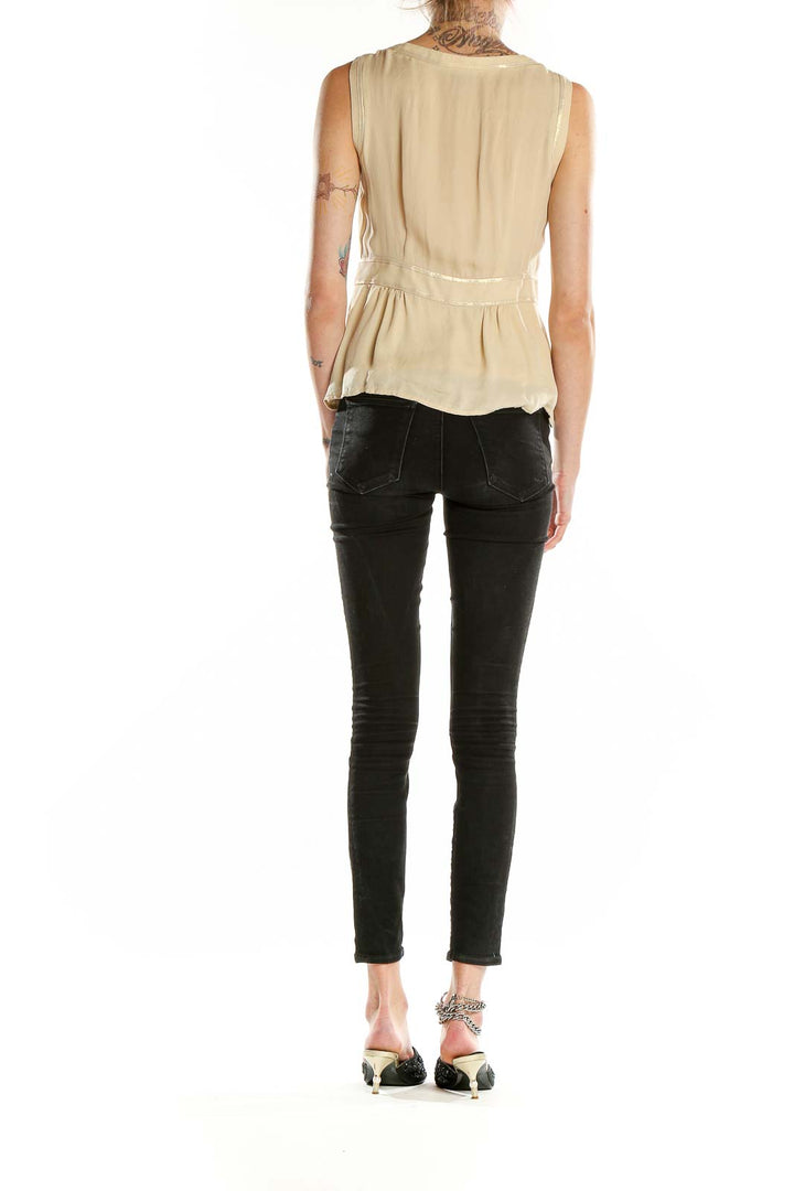 Side view of Nanette Lepore beige metallic silk sleeveless top showing peplum silhouette