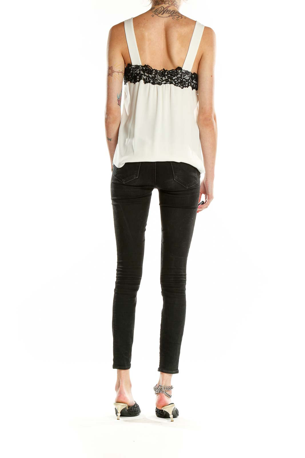Side view of White House Black Market sleeveless blouse showing lace detail
