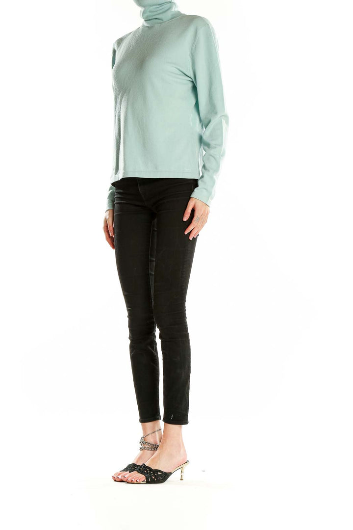 Front view of mint green Faconnable turtleneck sweater on model