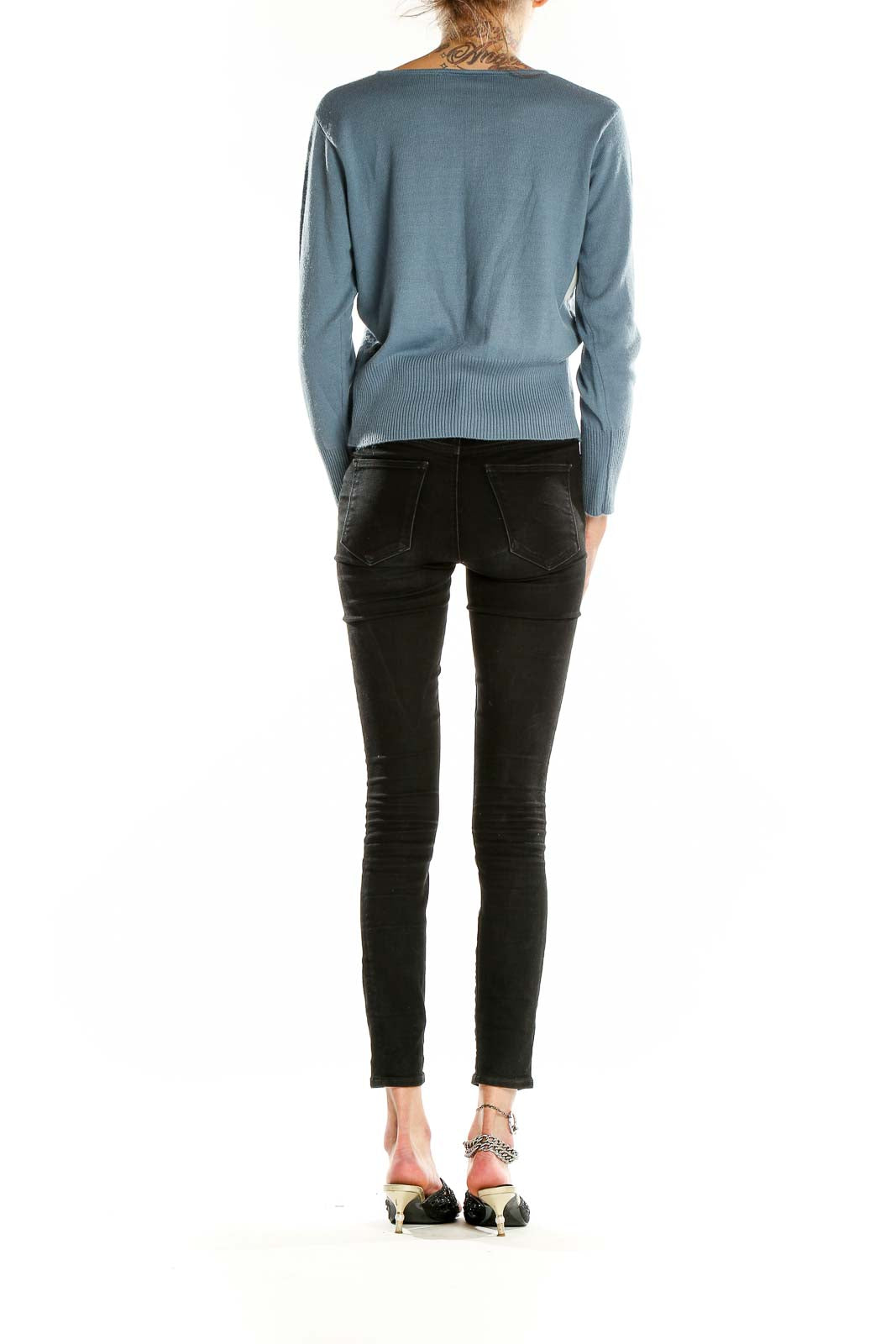 Side view of Norton McNaughton blue striped acrylic knit sweater on model