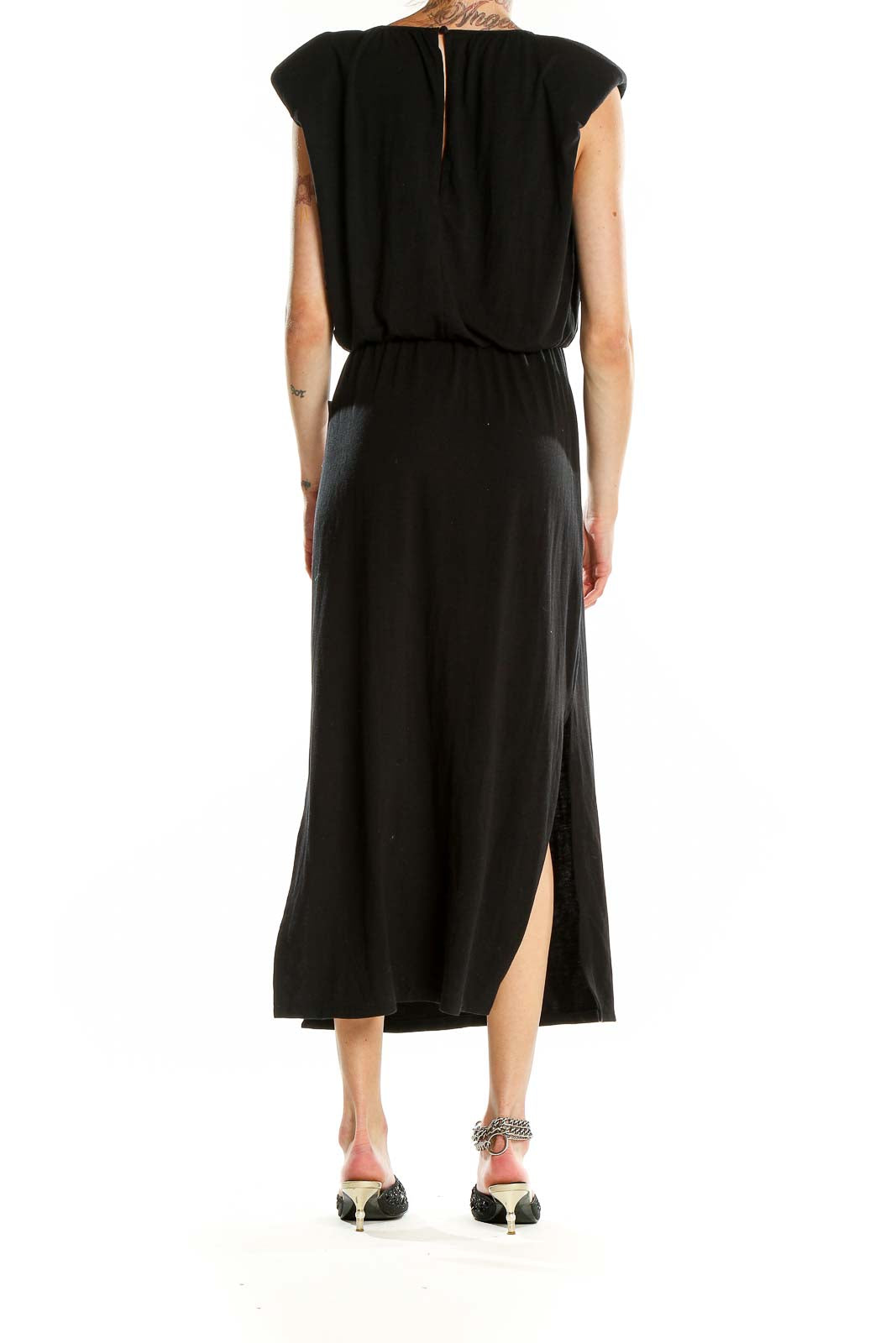 Side view of Wayf black maxi dress showcasing the elegant side slit