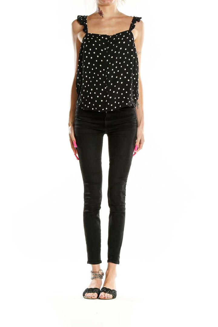 Front view of Madewell black polka dot tank top with ruffle straps