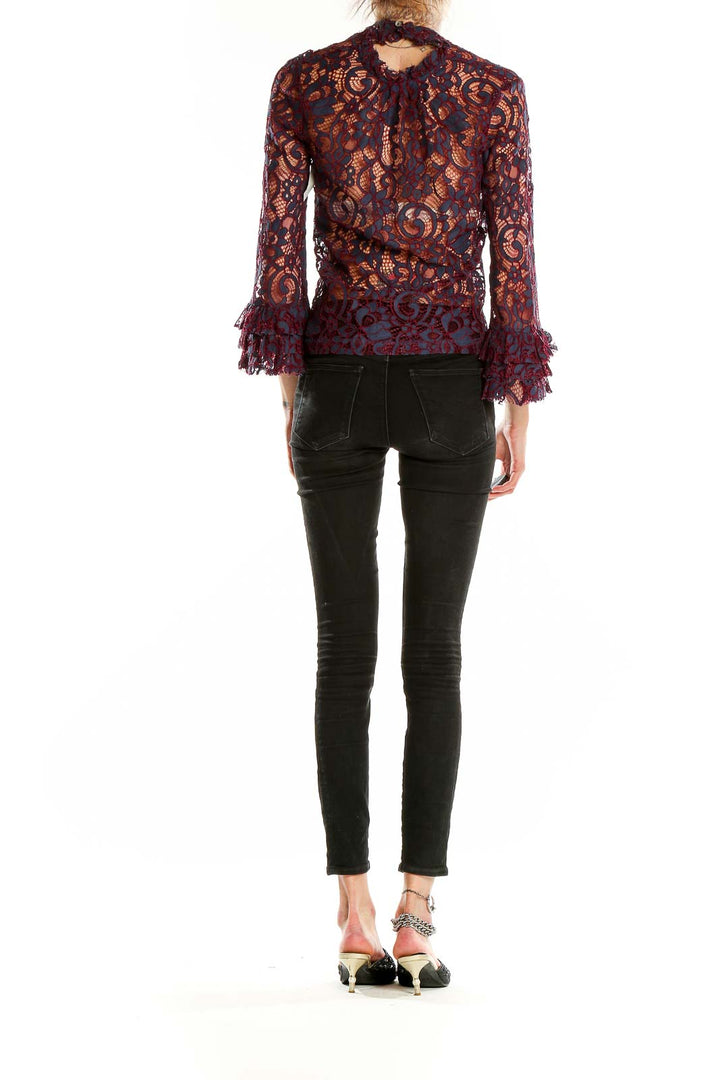 Side view of model wearing Willow & Clay burgundy lace crop top with black jeans