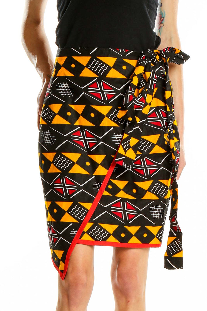 Front view of Heritage Clothing geometric print wrap skirt with black, orange, and red pattern