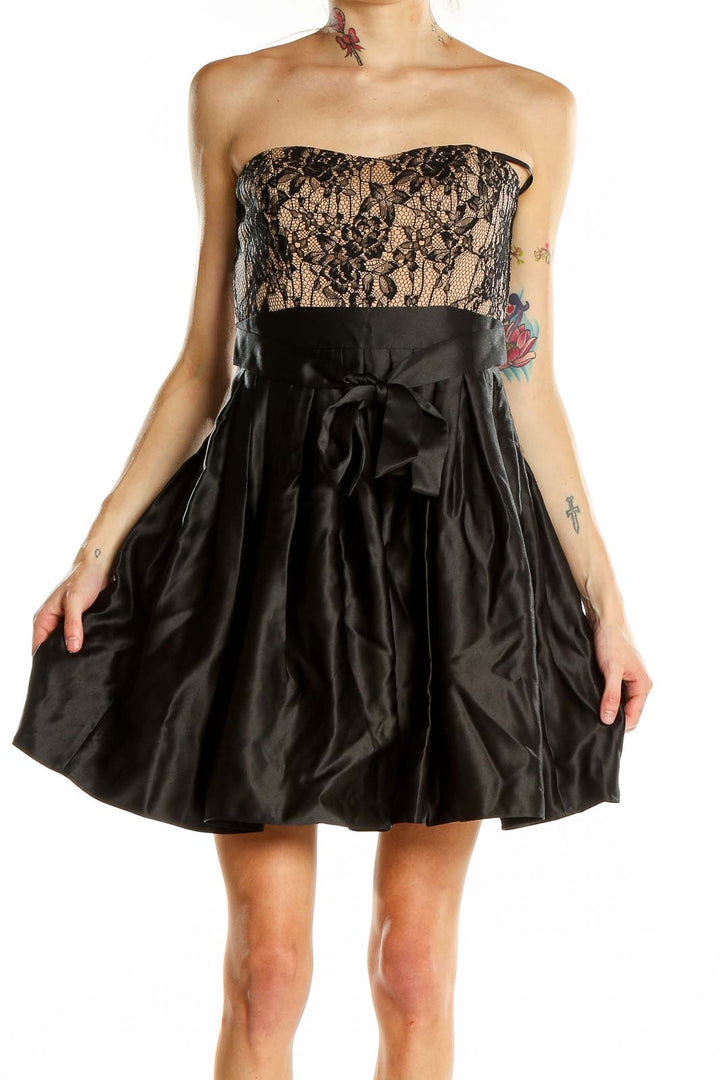 Front view of Aidan Mattox black lace strapless cocktail dress with nude underlay