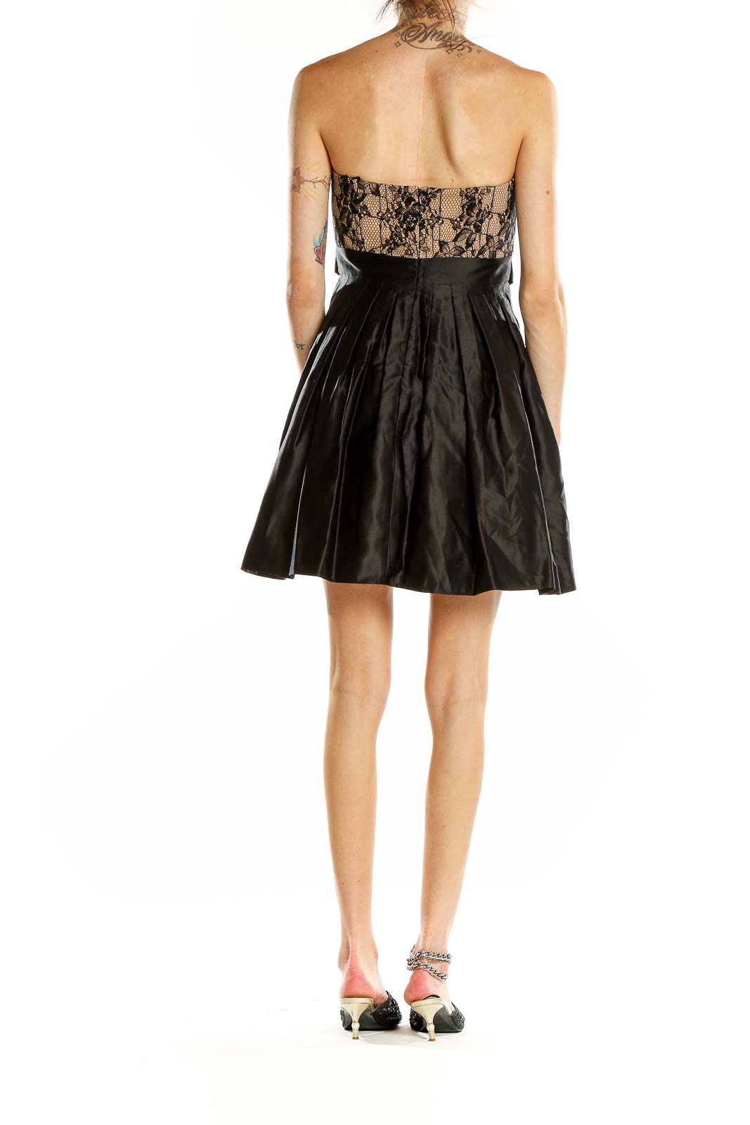 Side view of Aidan Mattox black lace strapless cocktail dress showing pleated skirt and satin bow