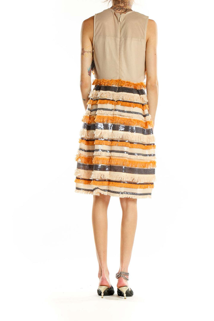 Back view of orange and cream striped fringe cocktail dress showing full skirt