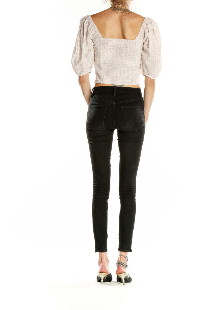 Side view of Abercrombie & Fitch white gingham puff sleeve crop top with black jeans