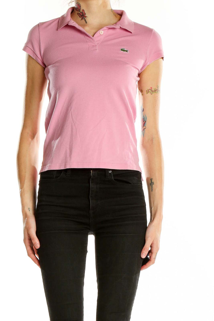 Front view of pink Lacoste polo shirt on model