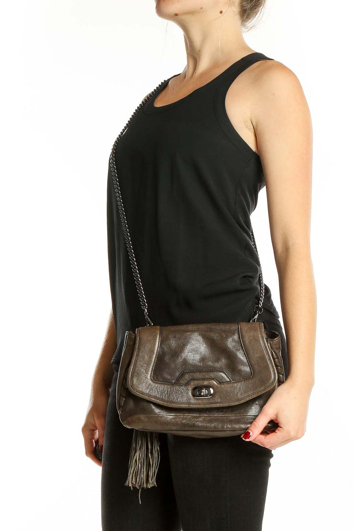 Front view of Cynthia Rowley brown leather crossbody bag with tassel