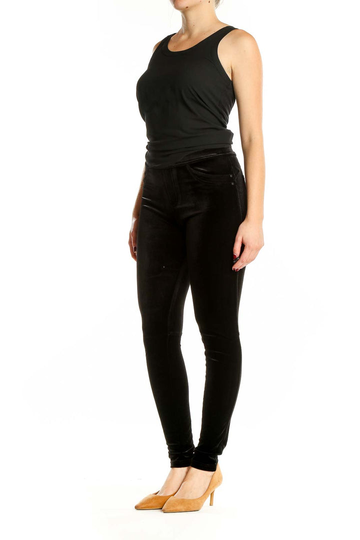 Front view of Sanctuary black velvet skinny pants on model