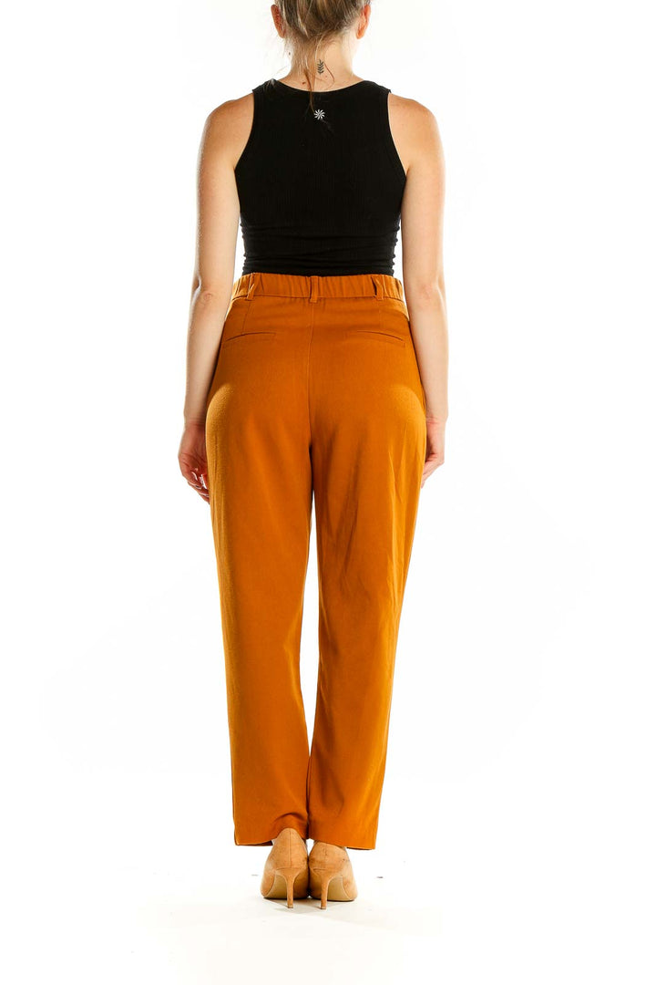 Back view of Zara orange high-waisted pleated trousers on model