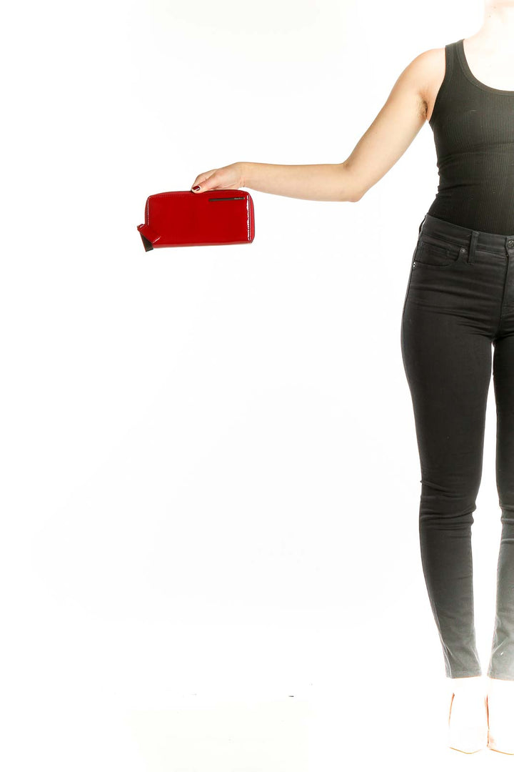 Red patent leather zip-around clutch by Kenneth Cole New York, front view