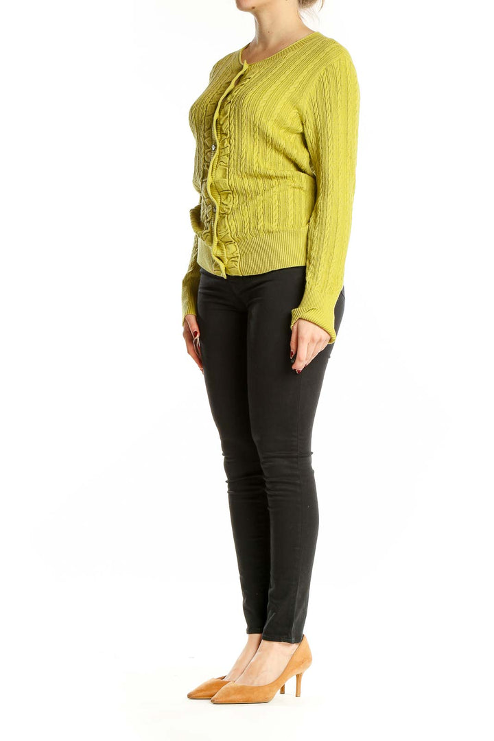 Front view of chartreuse Eddie Bauer cable knit cardigan with button-up front and ruffle detail