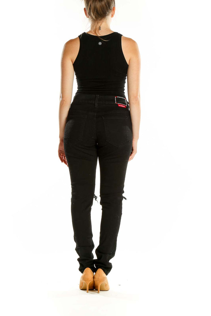 Back view of black distressed skinny jeans showing slim fit and pocket design