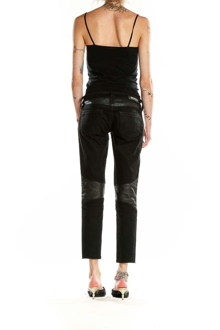 Back view of True Religion black cropped jeans showing leather pocket accents