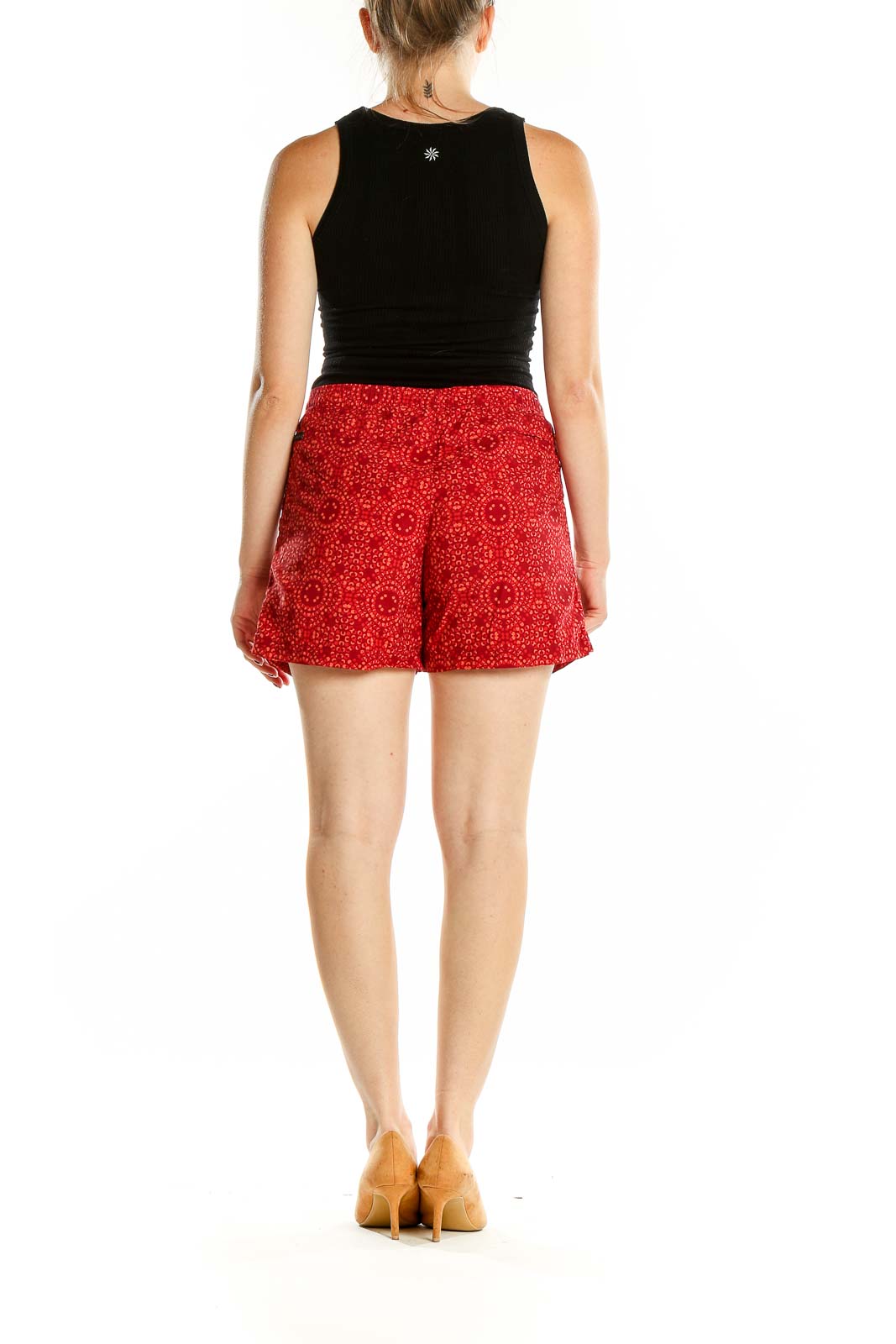 Back view of red patterned Columbia shorts on model