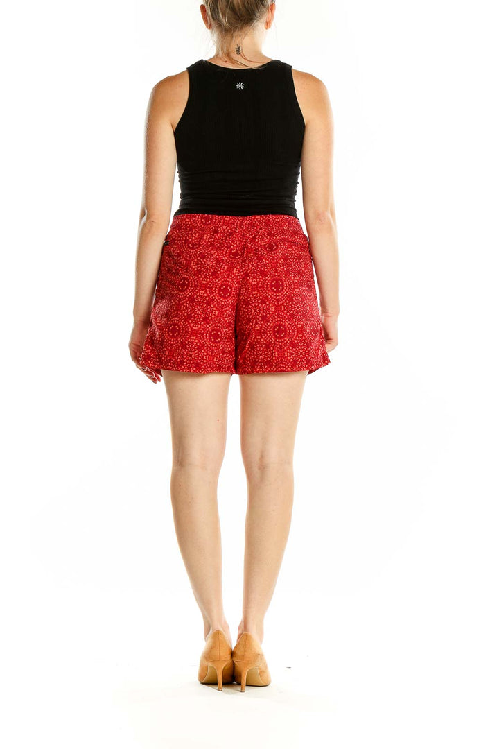 Back view of red patterned Columbia shorts on model