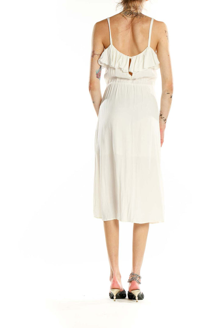 Back view of white Leith midi sundress showing open back design and flowy skirt