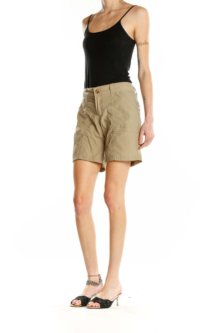 Front view of khaki nylon cargo shorts with multiple pockets