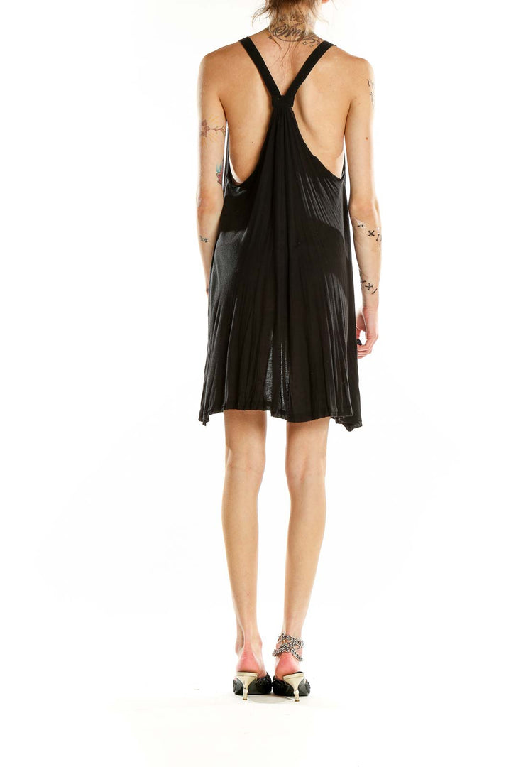 Back view of black Ecote mini dress showcasing racerback design