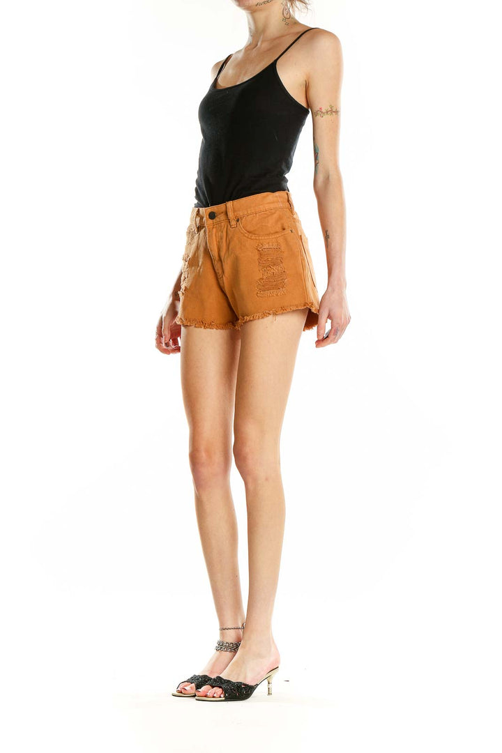 Front view of orange distressed Billabong cotton shorts
