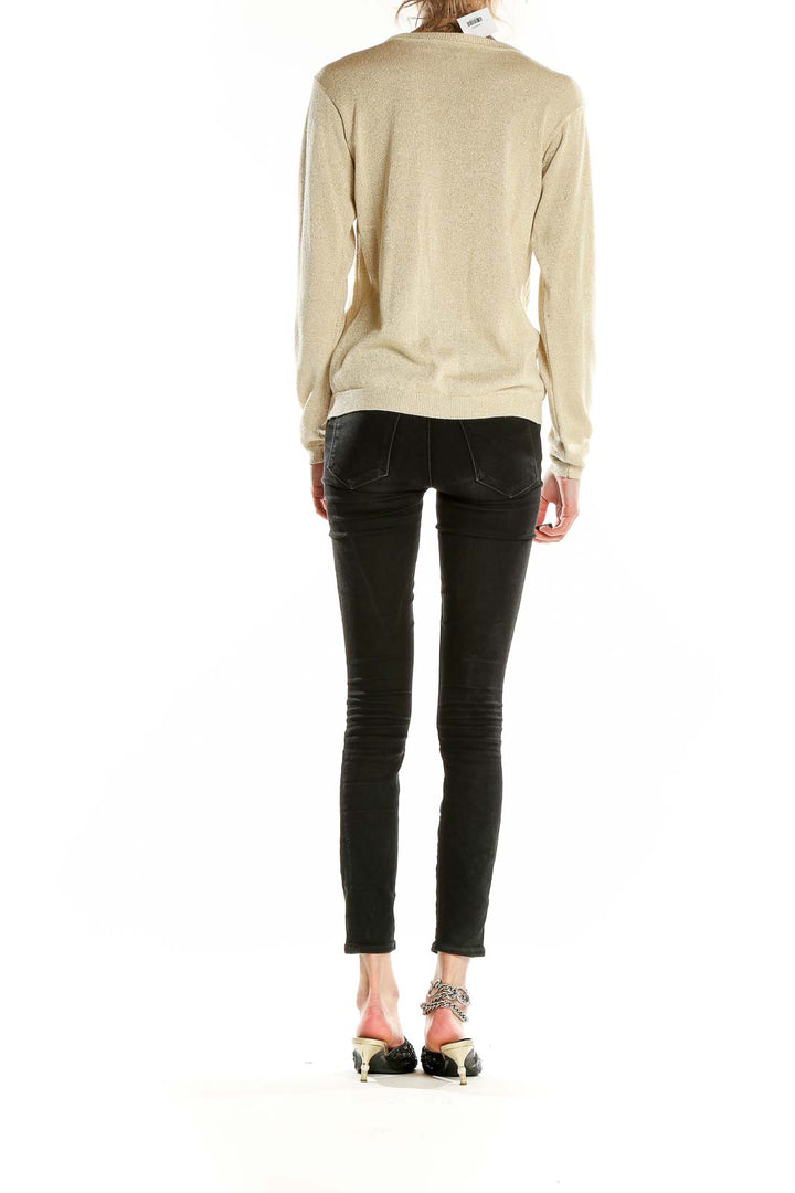 Back view of JOSEPH A. beige metallic silk knit sweater on model with black pants