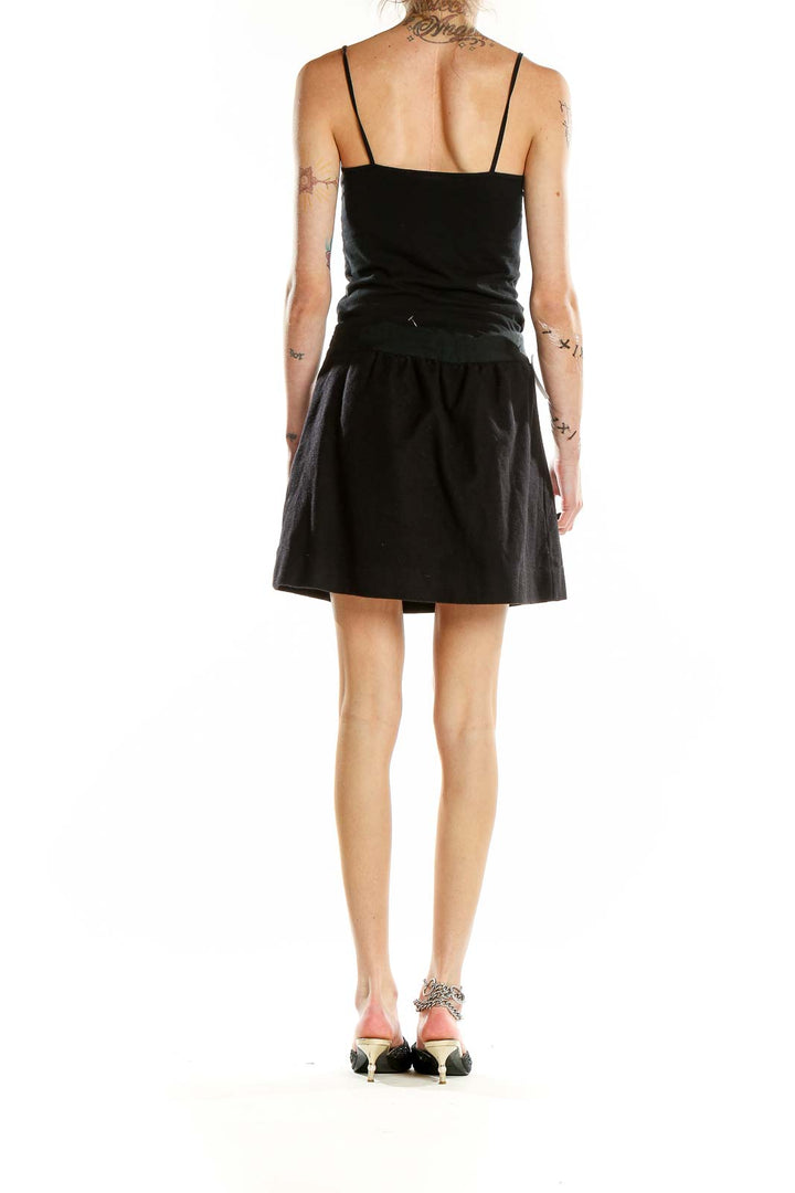 Back view of J.Crew black A-line mini skirt on model