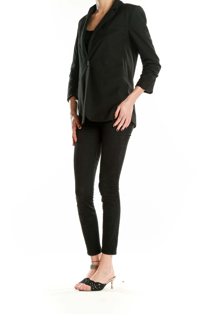 Front view of Elizabeth and James black blazer with single button closure