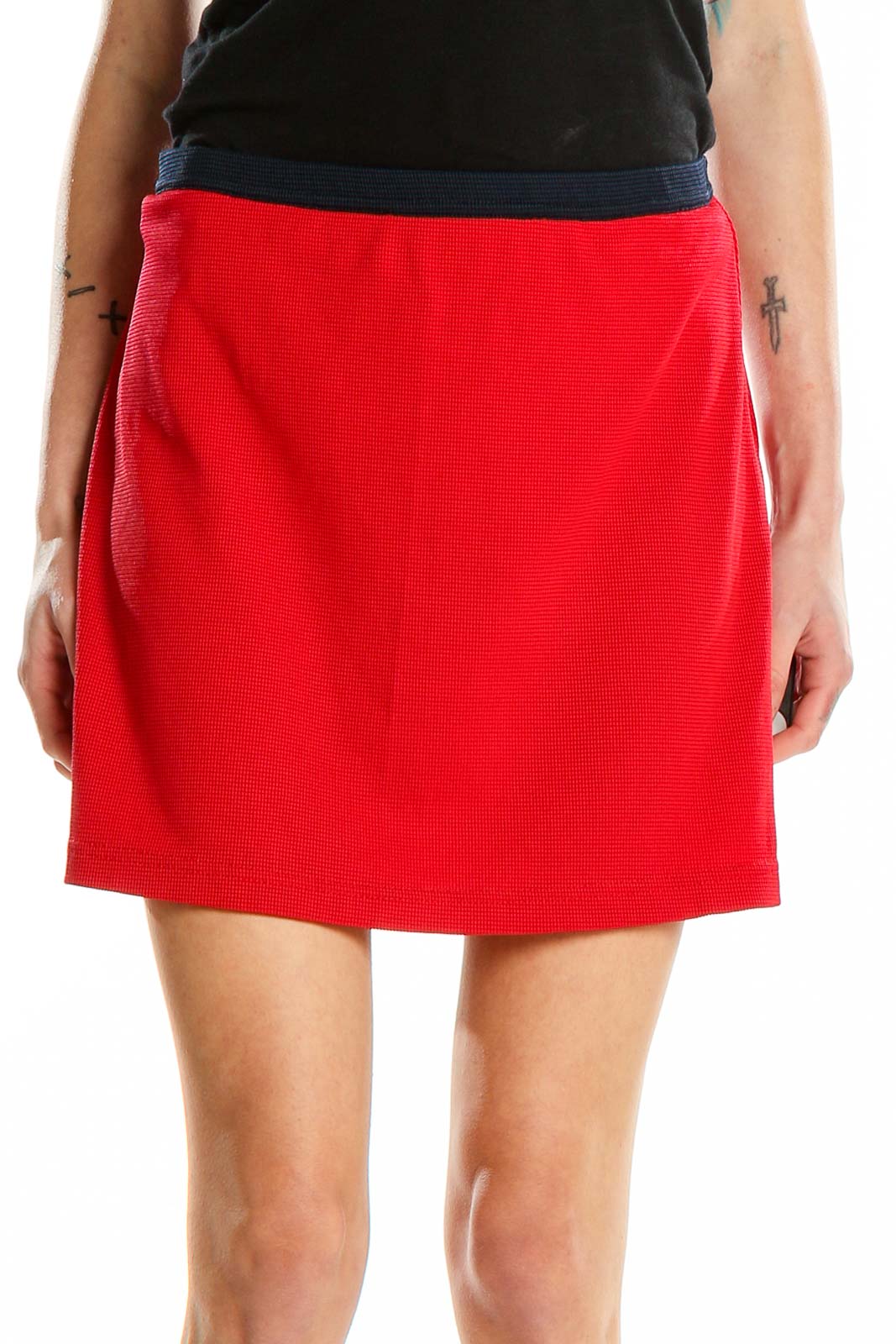 Front view of red Tail athletic skort with navy waistband