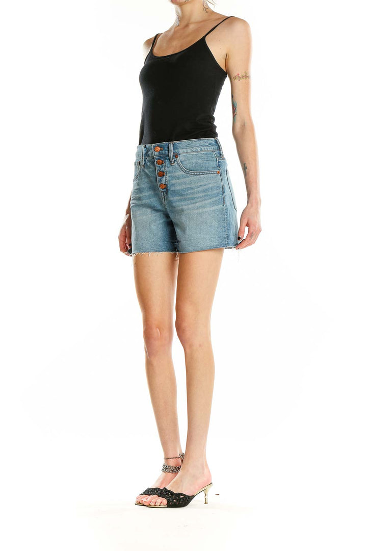 Front view of Madewell light blue denim shorts with button-front closure