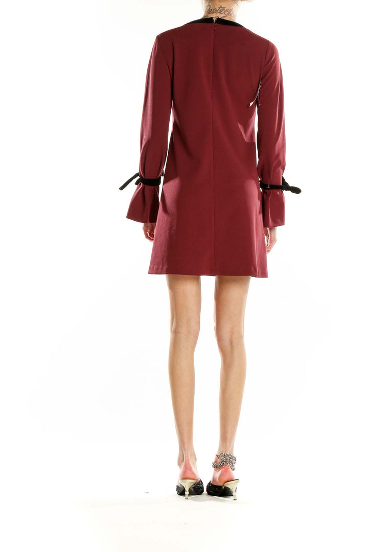 Back view of burgundy Donna Morgan mini dress showing A-line silhouette and bell sleeves