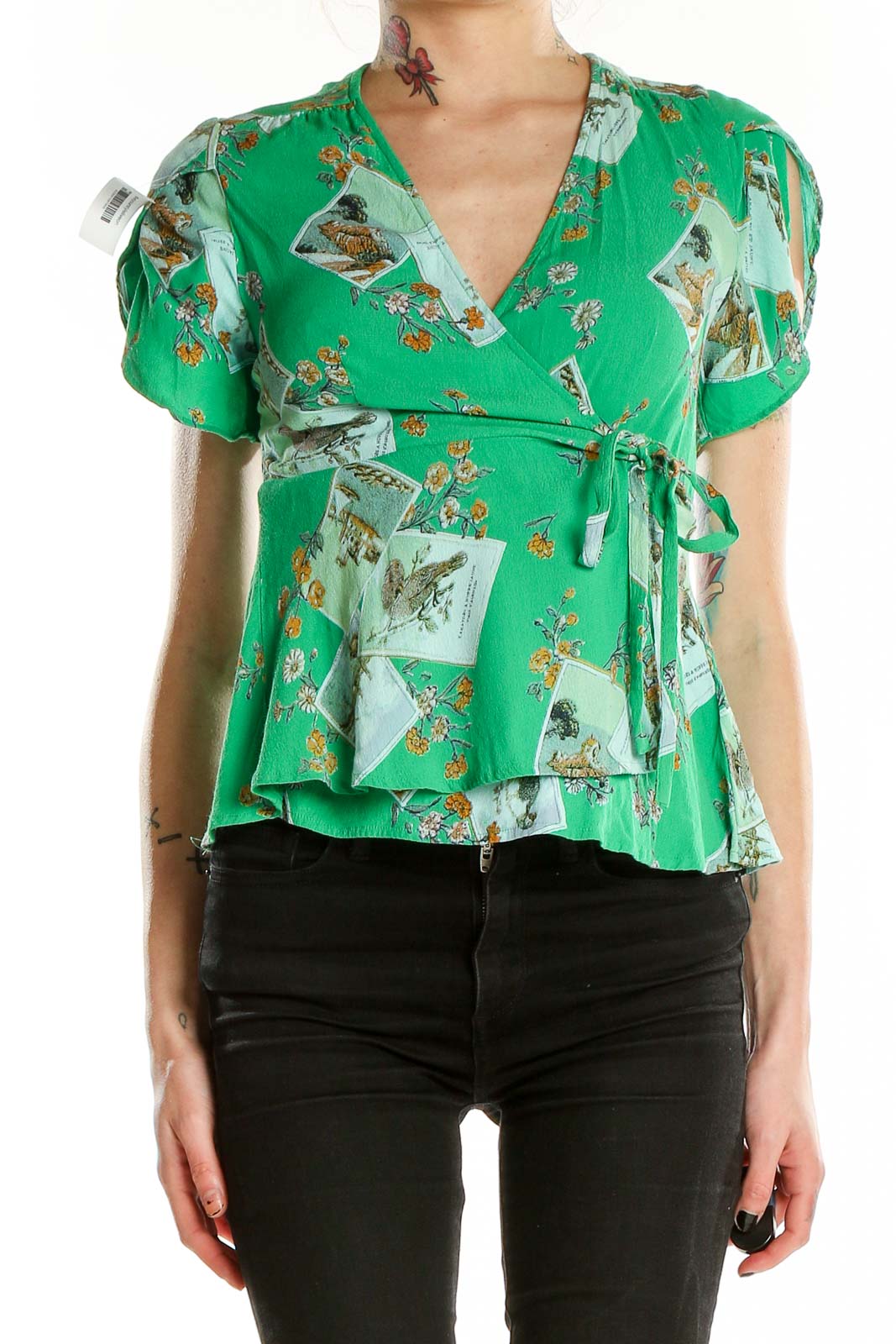 Front view of Meadow Rue green floral wrap blouse with puff sleeves and peplum hem