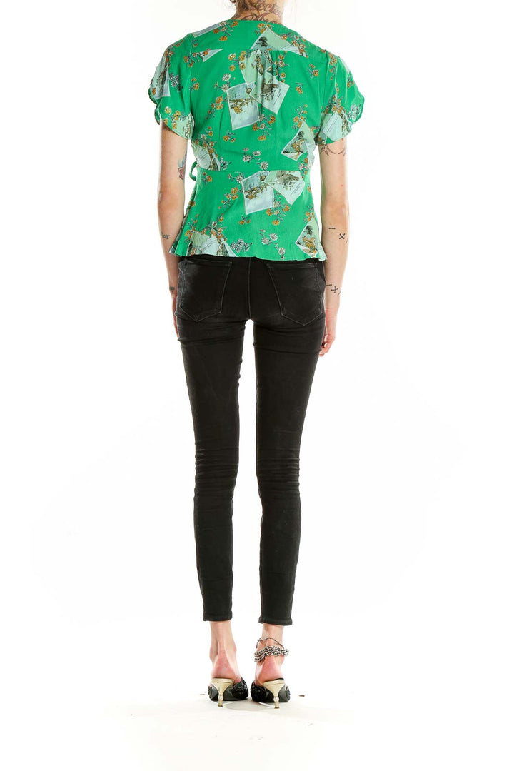 Back view of Meadow Rue green floral wrap blouse showing peplum detail and vintage photo print