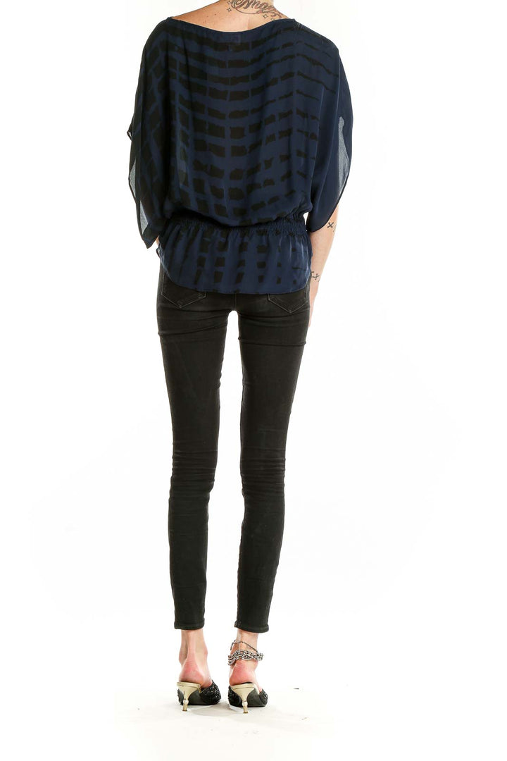 Back view of Parker navy silk blouse showing geometric print and relaxed fit